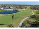 Aerial view of golf course community with pond and clubhouse at 766 Village Cir # 225, Venice, FL 34292