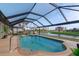 Relaxing pool area with covered lanai overlooking canal at 92 White Marsh Ln, Rotonda West, FL 33947