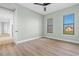 Bedroom with wood-look floors, large windows, and access to hallway at 95 Vivante Blvd # 9534, Punta Gorda, FL 33950