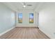 Spacious bedroom with large windows, wood-look floors, and ceiling fan at 95 Vivante Blvd # 9534, Punta Gorda, FL 33950