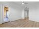 Bedroom with wood-look floors, private balcony access, and ceiling fan at 95 Vivante Blvd # 9534, Punta Gorda, FL 33950