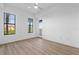 Bright bedroom with wood-look floors, two large windows, and a balcony at 95 Vivante Blvd # 9534, Punta Gorda, FL 33950