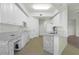 Modern kitchen with white cabinets, granite countertops, and stainless steel appliances at 95 Vivante Blvd # 9534, Punta Gorda, FL 33950