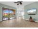 Bright living room with tiled floors, balcony access, and a ceiling fan at 95 Vivante Blvd # 9534, Punta Gorda, FL 33950
