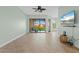 Living room with tiled floors, balcony access, and ceiling fan at 95 Vivante Blvd # 9534, Punta Gorda, FL 33950