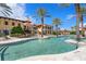 Resort-style pool with palm trees and Mediterranean-style building at 95 Vivante Blvd # 9534, Punta Gorda, FL 33950
