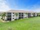 Condo building with balconies and a grassy area at 175 Kings Hwy # 718, Punta Gorda, FL 33983