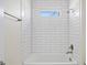 Bathroom featuring white subway tile, bathtub, and shower fixtures at 1100 S Wapello St, North Port, FL 34286