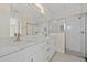Modern bathroom featuring double vanity with stone countertop and tiled shower with glass door at 1100 S Wapello St, North Port, FL 34286