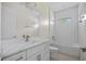 Modern bathroom with tiled shower/tub and vanity with stone countertop at 1100 S Wapello St, North Port, FL 34286