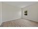 Bedroom featuring wood-look floors, white walls and window at 1100 S Wapello St, North Port, FL 34286