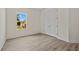 Bedroom with window and closet with double doors at 1100 S Wapello St, North Port, FL 34286