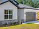 Lovely single-Gathering home featuring neutral siding, a gray roof, and a spacious garage at 1100 S Wapello St, North Port, FL 34286