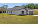 Single-story home with a two-car garage and neutral tones at 1100 S Wapello St, North Port, FL 34286