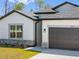 Beautiful house featuring a garage, neutral color scheme, and manicured lawn at 1100 S Wapello St, North Port, FL 34286