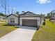 Charming home with a spacious two-car garage and a long driveway at 1100 S Wapello St, North Port, FL 34286