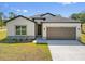 A charming home with a gray roof, neutral siding, and a well-manicured front lawn at 1100 S Wapello St, North Port, FL 34286