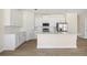 Bright, modern kitchen with white cabinets, stainless steel appliances, and an island at 1100 S Wapello St, North Port, FL 34286