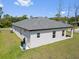 View of the home's lanai, sliding doors and well-kept backyard at 1100 S Wapello St, North Port, FL 34286