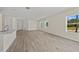 Spacious living room with wood-look floors and plenty of natural light at 1100 S Wapello St, North Port, FL 34286