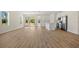 Bright, open-concept living room with sleek wood floors leading to the modern kitchen at 1100 S Wapello St, North Port, FL 34286