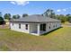 Rear exterior view showing the home's private, covered lanai at 1100 S Wapello St, North Port, FL 34286