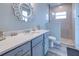 Bathroom features a vanity with quartz countertop and a walk-in shower at 1450 Kiwi Ct, Punta Gorda, FL 33950