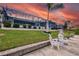 Landscaped backyard with canal views and seating at 1450 Kiwi Ct, Punta Gorda, FL 33950