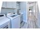 Convenient laundry room includes a sink and cabinets at 1450 Kiwi Ct, Punta Gorda, FL 33950
