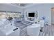 Spacious living area with white furniture, large TV, and pool view at 1450 Kiwi Ct, Punta Gorda, FL 33950