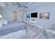 Main bedroom with king bed, sitting area, and large TV at 1450 Kiwi Ct, Punta Gorda, FL 33950