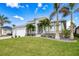 Two-story house with a large yard and palm trees at 1450 Kiwi Ct, Punta Gorda, FL 33950