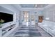Living room with white couches, built-in shelving, and wood-look floors at 1450 Kiwi Ct, Punta Gorda, FL 33950