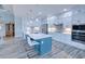 Modern kitchen with white cabinets, quartz countertops and teal island at 1450 Kiwi Ct, Punta Gorda, FL 33950
