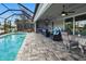 Relaxing poolside patio with seating and dining areas at 1450 Kiwi Ct, Punta Gorda, FL 33950