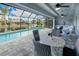 Enclosed pool and patio area with seating and canal views at 1450 Kiwi Ct, Punta Gorda, FL 33950