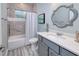 Bathroom with tub/shower combo, single vanity, and gray tile at 1450 Kiwi Ct, Punta Gorda, FL 33950