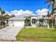 Stunning curb appeal: single Gathering home with a metal roof and paved driveway at 1450 Kiwi Ct, Punta Gorda, FL 33950