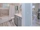 Bathroom with tub/shower combo and vanity, view of living room at 1450 Kiwi Ct, Punta Gorda, FL 33950