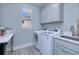 Bright laundry room with washer, dryer, and ample storage at 1450 Kiwi Ct, Punta Gorda, FL 33950