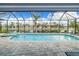 Large pool and spa with canal views from screened enclosure at 1450 Kiwi Ct, Punta Gorda, FL 33950
