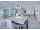 Open concept dining area with a large square table and access to the kitchen and patio at 1450 Kiwi Ct, Punta Gorda, FL 33950