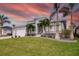 Two-story house with a three car garage and palm trees at 1450 Kiwi Ct, Punta Gorda, FL 33950