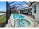 Inviting pool and spa with covered patio and outdoor seating at 1450 Kiwi Ct, Punta Gorda, FL 33950