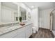 Stylish bathroom featuring double sinks, granite countertops, and modern fixtures offers a luxurious experience at 16307 Alcira Cir, Punta Gorda, FL 33955