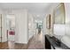 Bright hallway with wood floors, modern decor, and open doorway views of a bedroom and living room area at 16307 Alcira Cir, Punta Gorda, FL 33955