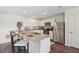 Modern kitchen with granite countertops, stainless steel appliances, and a functional island with bar seating at 16307 Alcira Cir, Punta Gorda, FL 33955