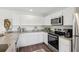 The kitchen showcases granite counters, stainless appliances, and dark wood floors at 16307 Alcira Cir, Punta Gorda, FL 33955