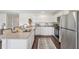 Modern kitchen boasts stainless steel appliances, granite countertops, and white cabinetry at 16307 Alcira Cir, Punta Gorda, FL 33955