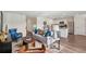 Cozy open-concept living room featuring a comfortable sofa, modern decor, and a view into the kitchen area at 16307 Alcira Cir, Punta Gorda, FL 33955